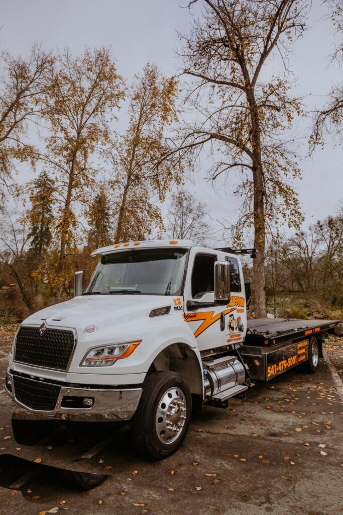 Caveman Towing flatbed tow truck, front view
