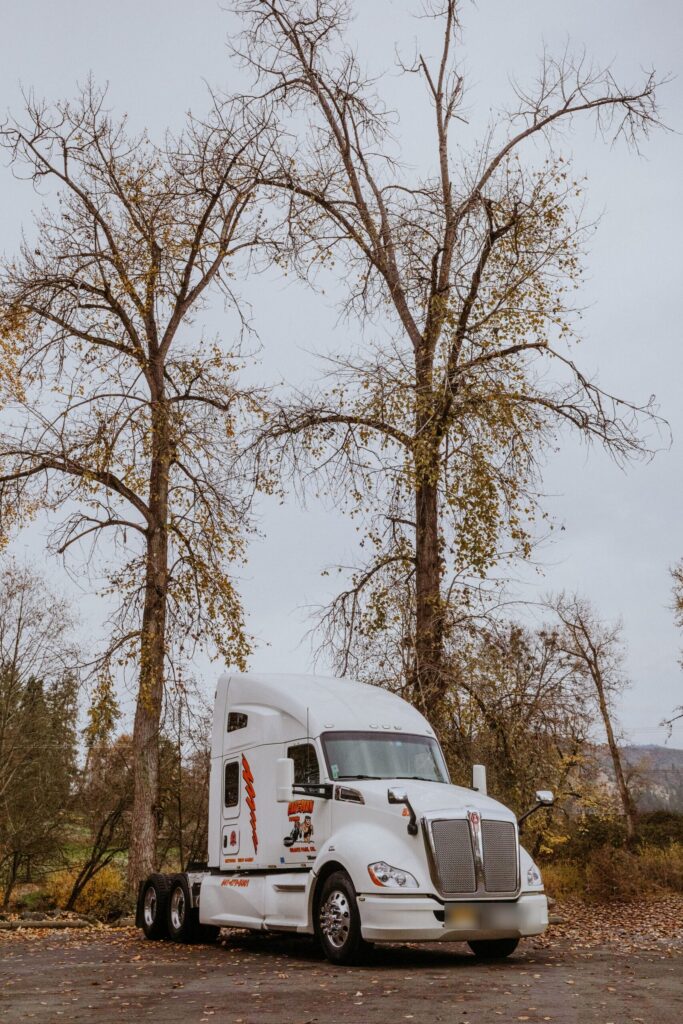 Caveman Towing semi tractor in an open lot